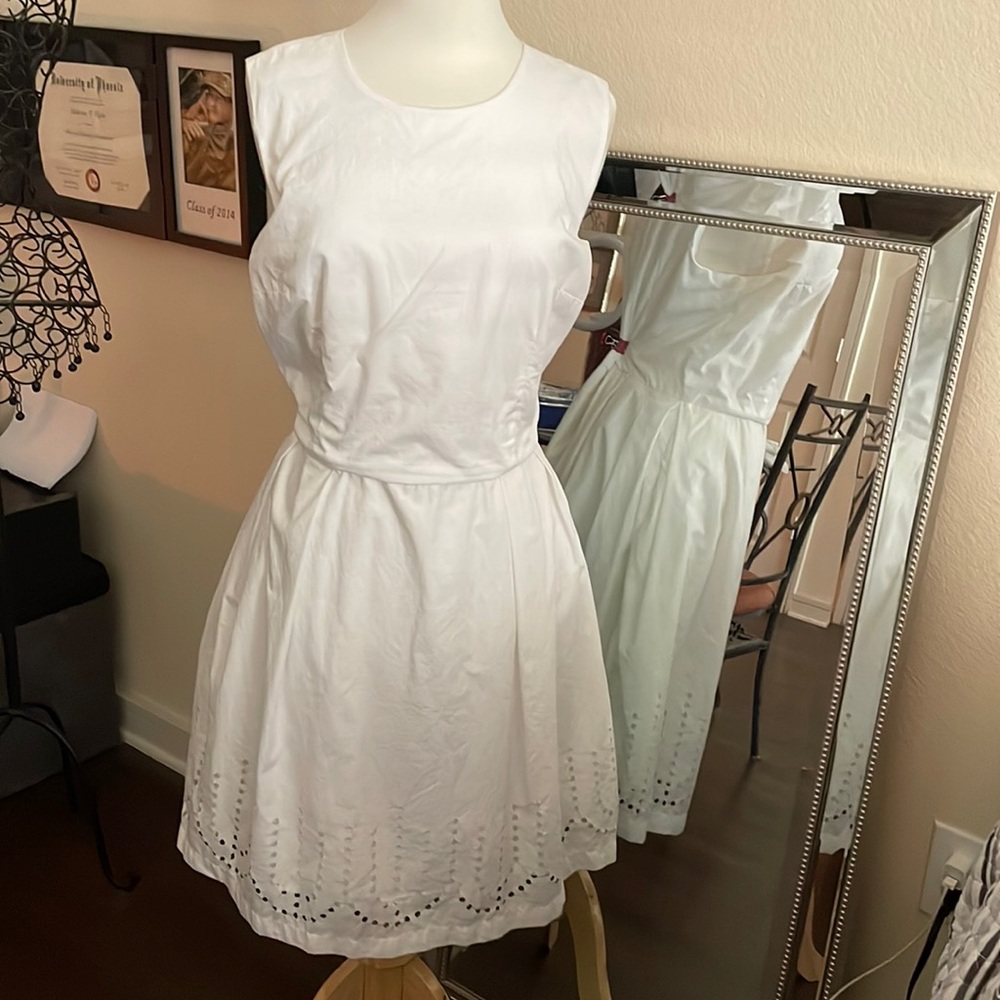 White sleeveless dress with laser cut details